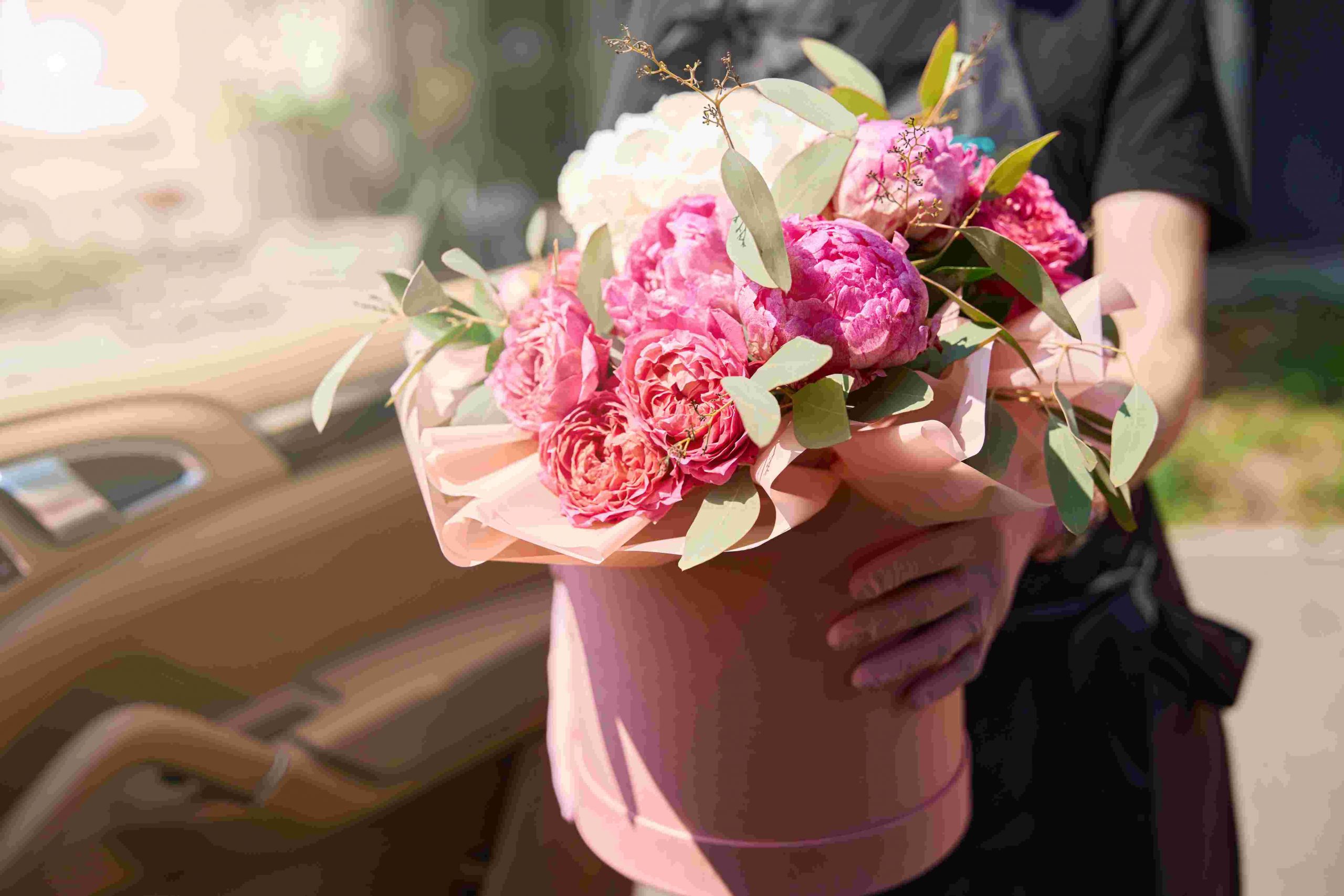 holding luxurious bouquet of flowers