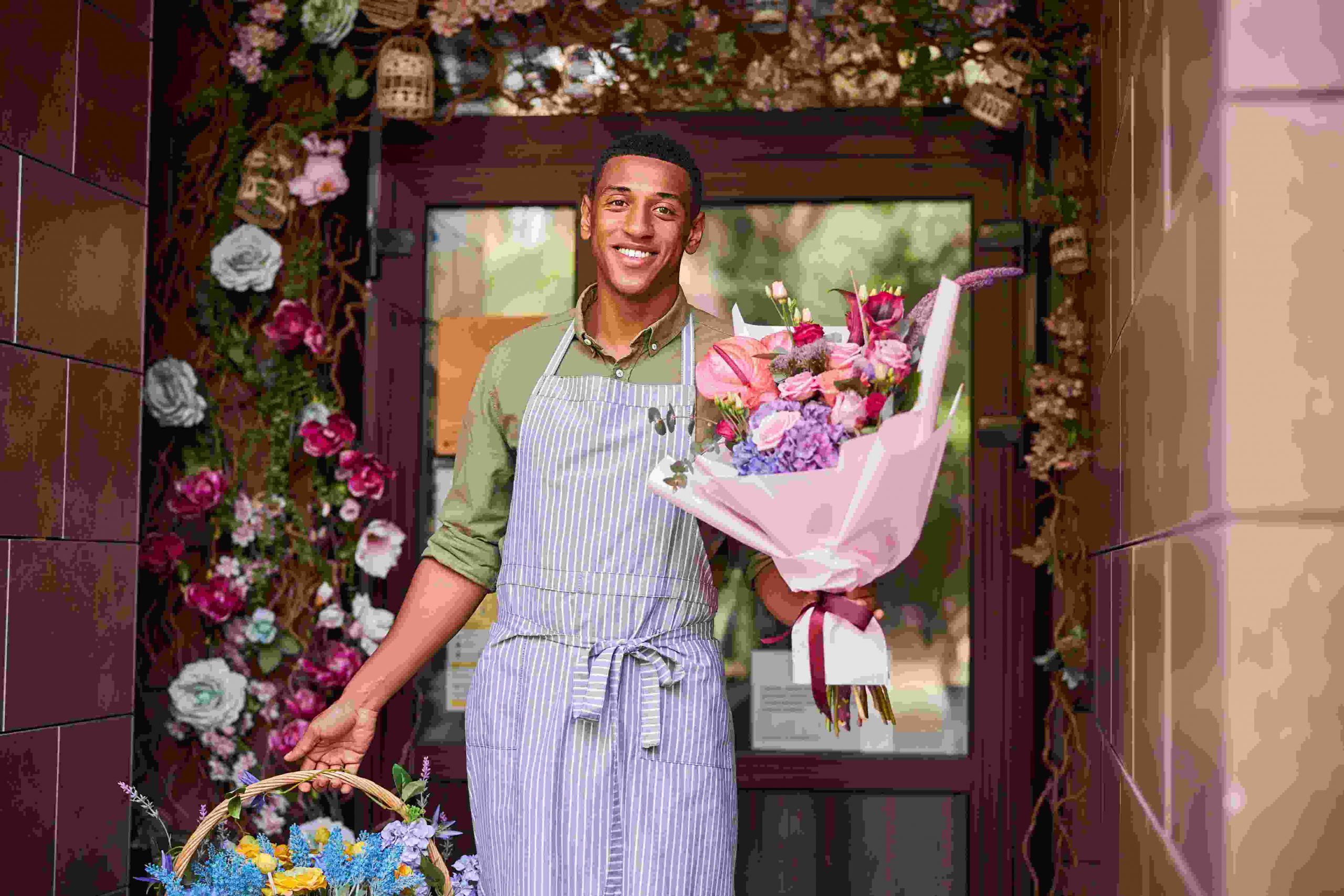 man carrying flowers in both hands