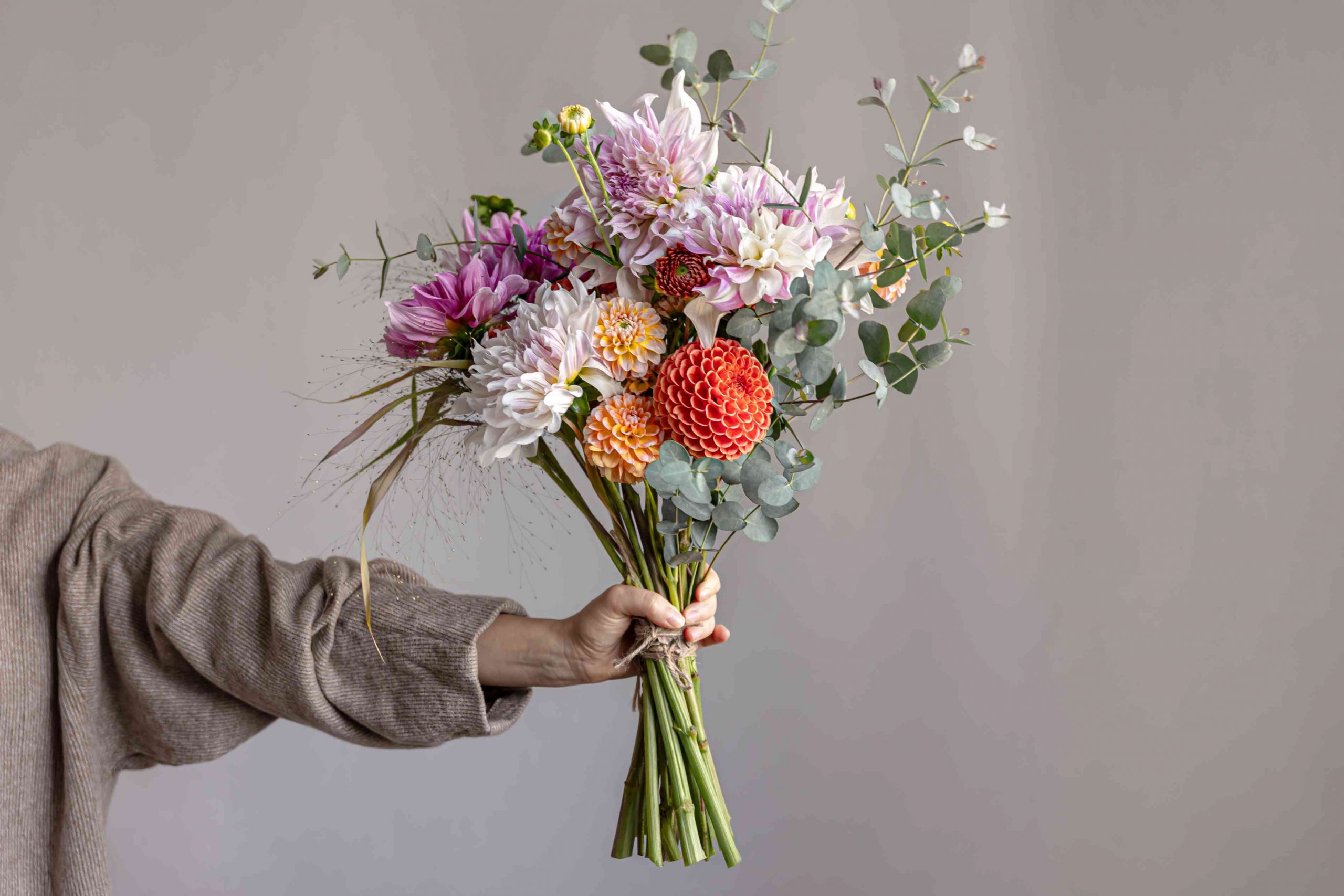 woman holding festive flower bouquet