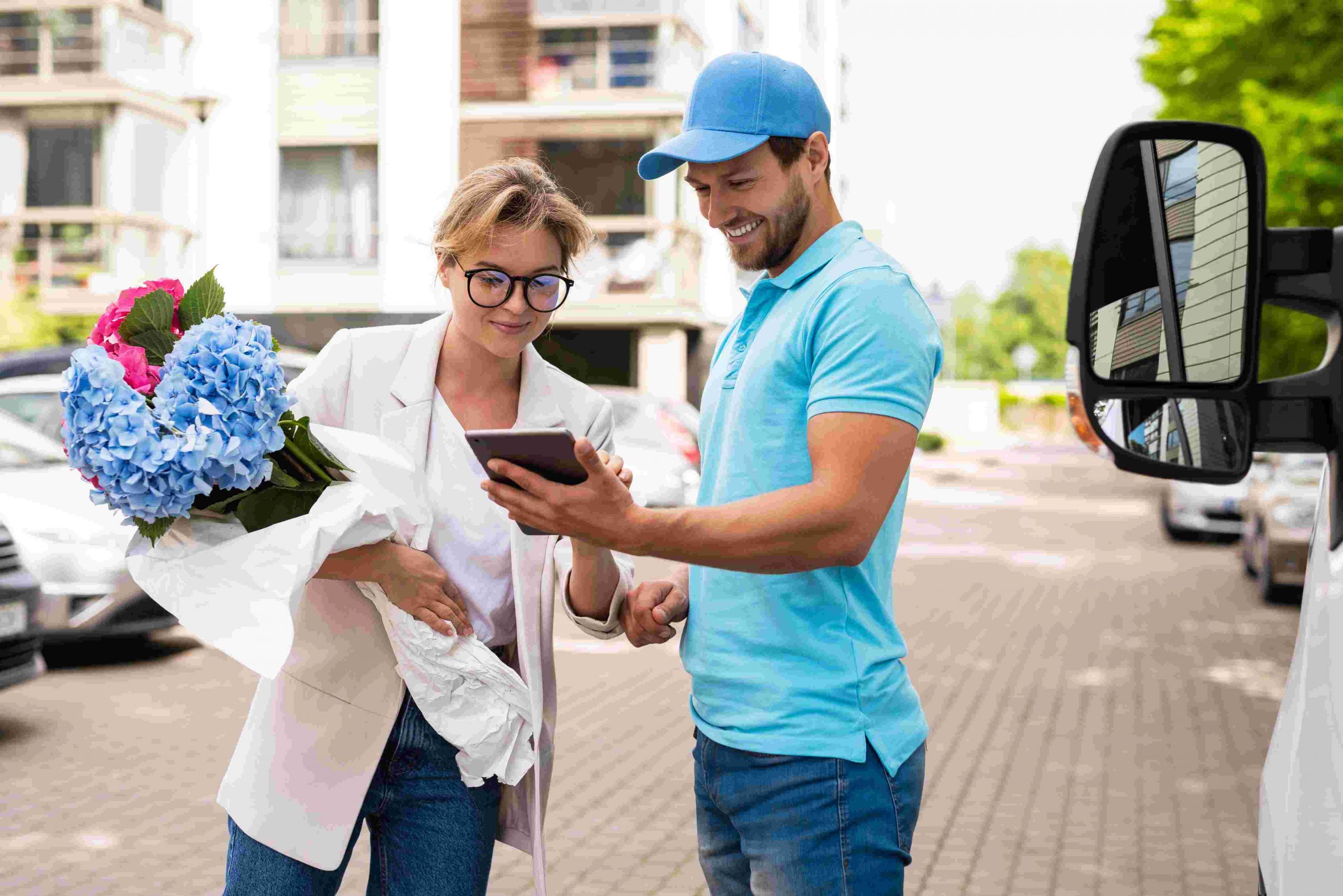 delivery man in blue uniform delivers flower