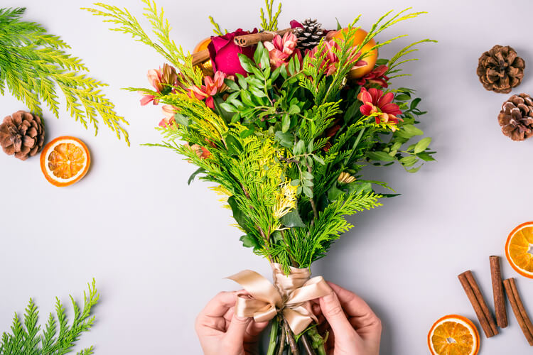 Hands arranging a winter bouquet for Australian flower gifting
